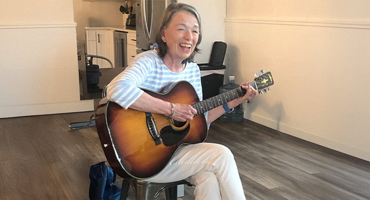 Sally Joyce plays the guitar for a Music Therapy group